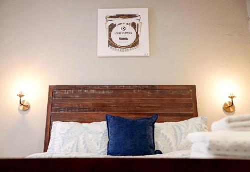 a bed with a blue pillow and a picture on the wall at Lil Havana-Brickell-South Beach in Miami