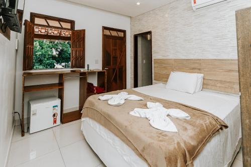 Ένα ή περισσότερα κρεβάτια σε δωμάτιο στο Hotel Fazenda Mirage