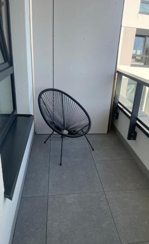 a black chair sitting on a floor in a building at AirPort Apartment Chopina in Warsaw
