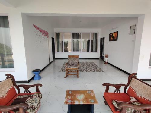 a living room with chairs and a coffee table at Sunshine Resort in Surai