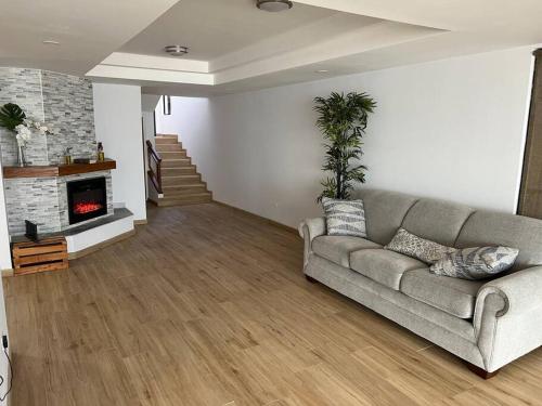 a living room with a couch and a fireplace at Oceanfront Home in Rosarito Beach in Santa Mónica Sur