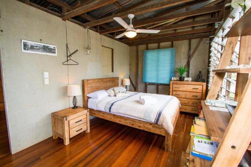 a bedroom with a bed and a ceiling fan at The Shack - Quaint, pet-friendly cottage in 1770 in Seventeen Seventy