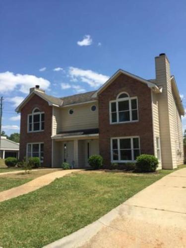 a large brick house with a driveway at The Parkside Townhome in Columbus