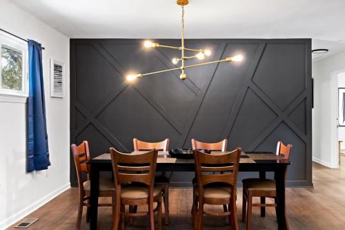 a dining room with a table and chairs at Elegant in Noir- Midcentury Modern Vibes in Chattanooga