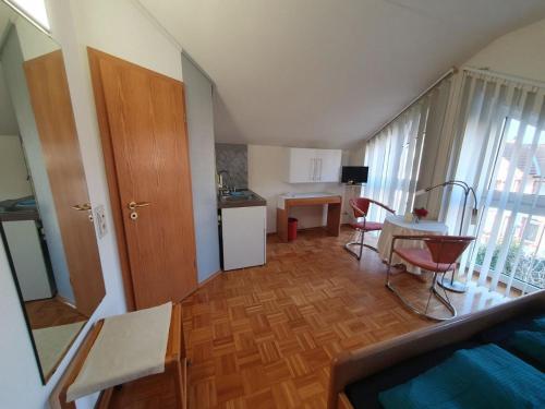 a living room with a kitchen and a dining room at ABM Apartment 32 in Zwingenberg