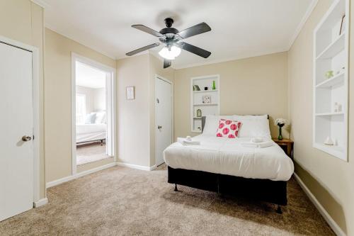 a bedroom with a bed and a ceiling fan at 15mins to Downtown- Adorable on Taylor Both Units in West Columbia