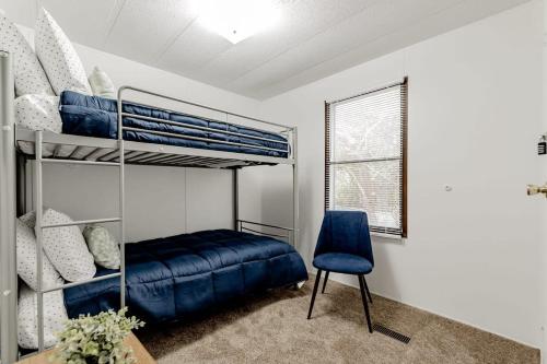 a bedroom with a bunk bed and a blue chair at 15mins to Downtown- Adorable on Taylor Both Units in West Columbia