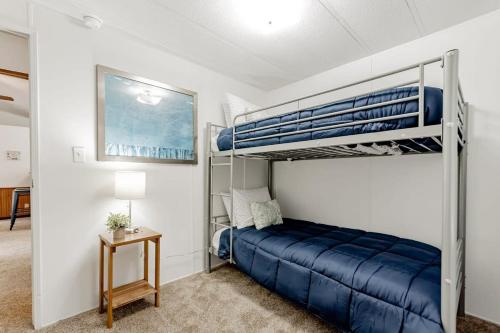 a bedroom with two bunk beds and a blue bed at 15mins to Downtown- Adorable on Taylor Both Units in West Columbia