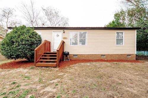 a house with a wooden staircase in front of it at 15mins to Downtown- Adorable on Taylor Both Units in West Columbia