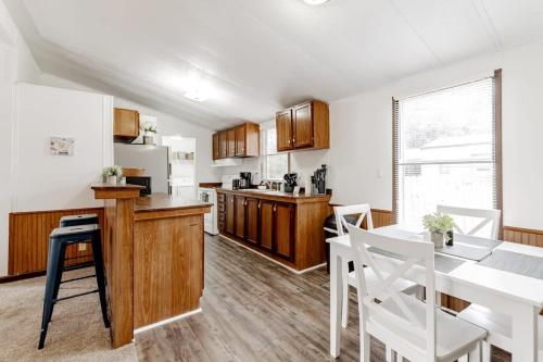 a kitchen with a table and white chairs and a counter at 15mins to Downtown- Adorable on Taylor Both Units in West Columbia