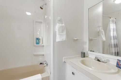 a white bathroom with a sink and a mirror at 15mins to Downtown- Adorable on Taylor Both Units in West Columbia