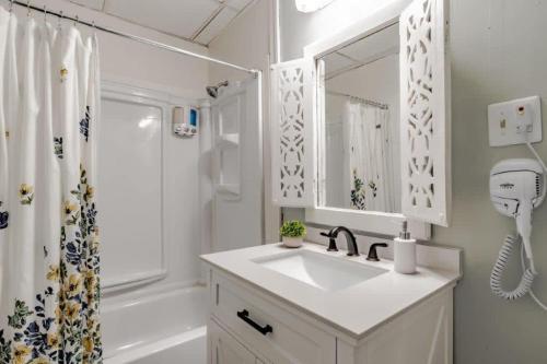 a white bathroom with a sink and a shower at Dauphin District Darling #1-Downtown, Restaurants in Mobile