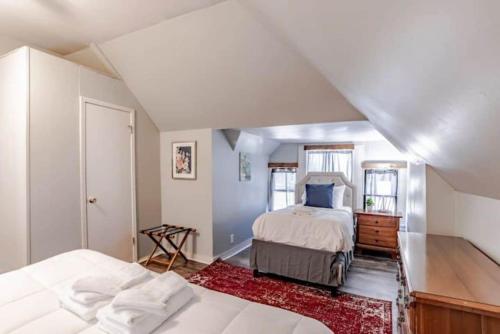 a bedroom with two beds in a attic at Dauphin District Darling #3-Downtown, Restaurants in Mobile