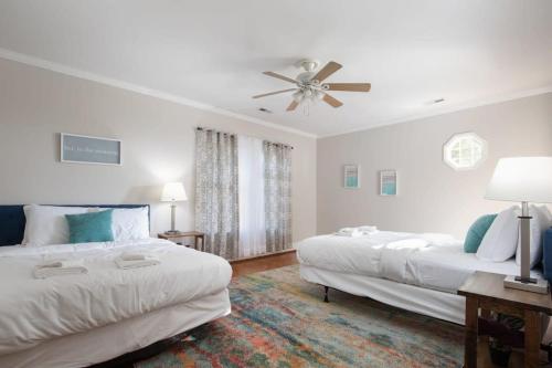 a bedroom with two beds and a ceiling fan at Redmont Revival-Whole House-Walkable-UAB in Birmingham