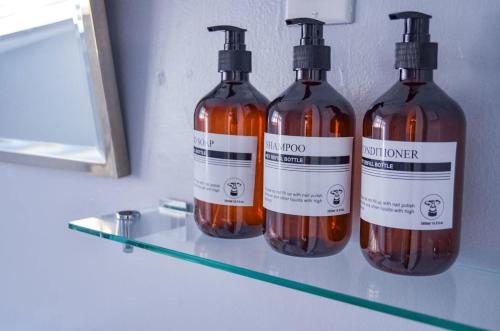 three bottles of alcohol sitting on a shelf at Perfectly Modern Craftsman- close to everything! in Mobile
