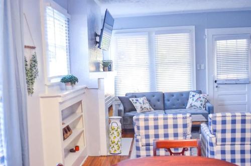 a living room with a blue couch and chairs at Perfectly Modern Craftsman- close to everything! in Mobile
