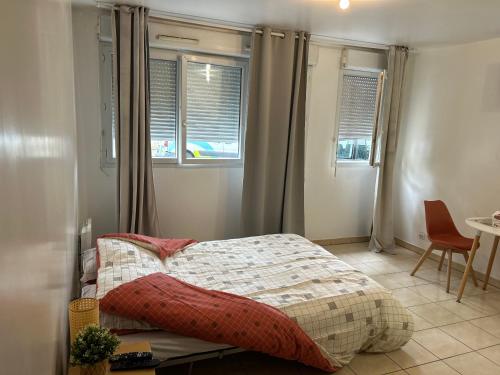 une chambre avec un lit et deux fenêtres dans l'établissement Studio à 2 pas du métro, à Clichy