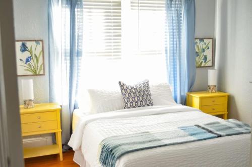 a bedroom with a white bed and a window at Perfectly Modern Craftsman- close to everything! in Mobile
