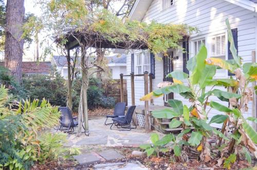 a backyard with chairs and a pergola at Perfectly Modern Craftsman- close to everything! in Mobile