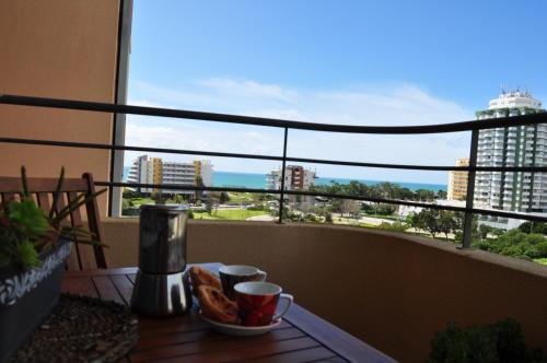 a table on a balcony with a view of a city at Portimão, Praia da Rocha in Portimão