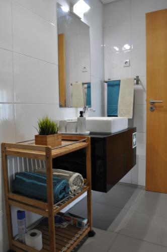 a bathroom with a sink and a mirror at Portimão, Praia da Rocha in Portimão