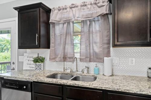 a kitchen with a sink and a window at Laid-Back on Lancelot Lane in Clarksville