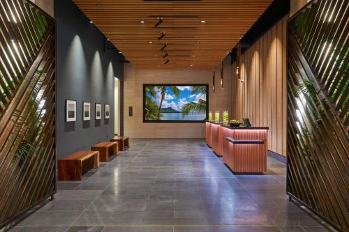 a lobby of a hotel with a reception desk and benches at Renaissance Honolulu Hotel & Spa in Honolulu