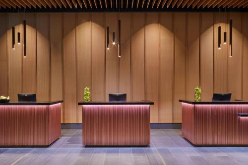 a row of desks in a lobby with potted plants at Renaissance Honolulu Hotel & Spa in Honolulu