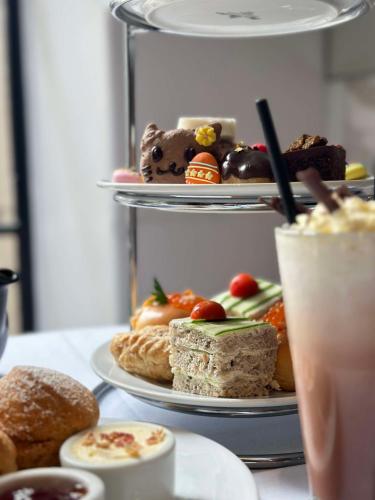 a table with three plates of food and a drink at Paradox Sydney in Sydney