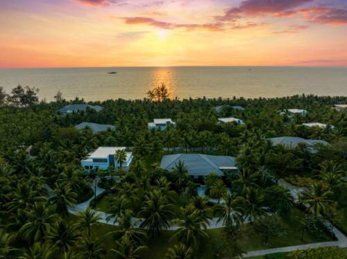 an aerial view of a resort with palm trees and the ocean at Radisson Blu Resort Phu Quoc in Phú Quốc