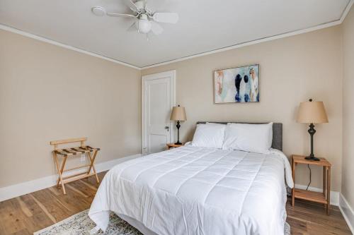 a white bedroom with a bed and a ceiling fan at Close to Hospital Dining & Notre Dame in South Bend