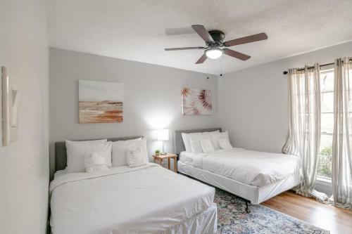 a bedroom with two beds and a ceiling fan at Parkhill Place- Mins from University of South AL in Mobile