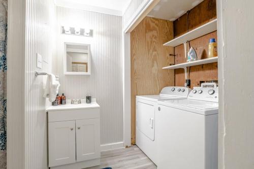 a white laundry room with a washer and dryer at Wonderstruck on Wendover- 20 Mins to Downtown in Mobile