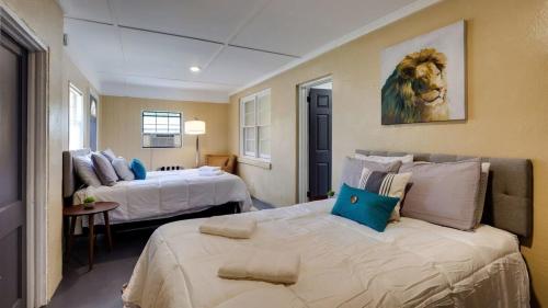 a bedroom with two beds and a lion painting on the wall at Retro Rainbow at Herb River-Green Grotto #9 in Savannah