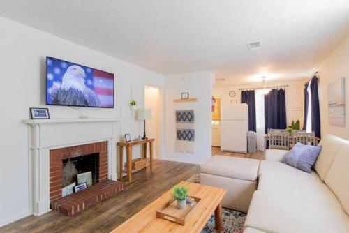 a living room with a couch and a fireplace at The Delightful Doubles- Unit E- Centrally Located in Columbus
