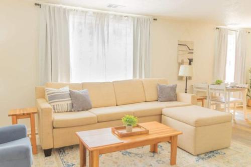 a living room with a couch and a table at The Delightful Doubles- Unit A- Centrally Located in Columbus