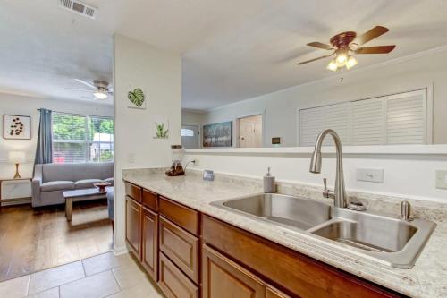 a kitchen with a sink and a ceiling fan at Covered Patio & Fenced Yard Lovely in Laurelwood in Savannah