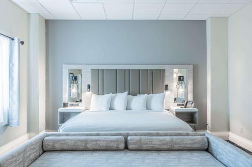 sypialnia z dużym łóżkiem z białymi poduszkami w obiekcie Inn on the Square, Ascend Hotel Collection w mieście Greenwood