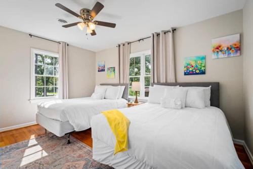 two beds in a room with two windows at 20 Mins to Downtown - Relaxing Rambler in Mobile
