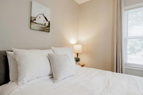 a white bed with white pillows in a bedroom at Mins to USC, Hospital, Zoo! Columbia Duet- 2 Units in West Columbia
