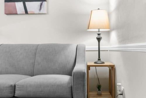 a lamp sitting on a table next to a couch at Two Kitchens Family Friendly in Forestdale in Birmingham