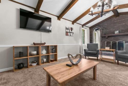 a living room with a wooden table and chairs at Two Kitchens Family Friendly in Forestdale in Birmingham