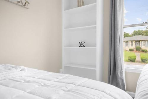 a bedroom with a white bed and a window at Two Kitchens Family Friendly in Forestdale in Birmingham