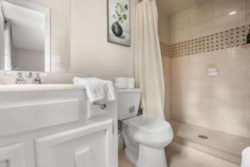 a white bathroom with a toilet and a sink at Two Kitchens Family Friendly in Forestdale in Birmingham