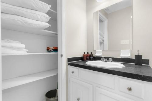 a white bathroom with a sink and a mirror at Two Kitchens Family Friendly in Forestdale in Birmingham