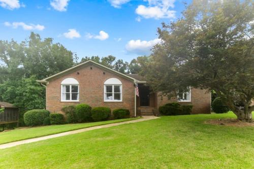 a brick house with a tree in the yard at Two Kitchens Family Friendly in Forestdale in Birmingham