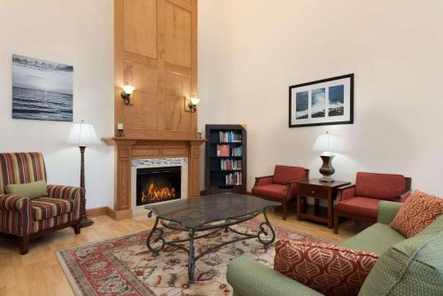 a living room filled with furniture and a fireplace at Country Inn & Suites by Radisson, St Augustine Downtown Historic District, FL in Saint Augustine