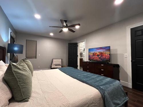 a bedroom with a bed and a ceiling fan at Spacious & Beautiful with Double Decks in Chapel Area in Sedona