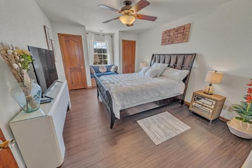 a bedroom with a bed and a ceiling fan at NEW! Spacious, Full Game Room, Ping Pong, Yoga, Golf Course, Pickle Ball! in Sedona