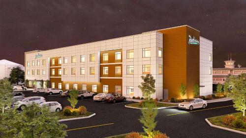 a rendering of a hotel with cars parked in a parking lot at Radisson Hotel Pendleton Airport in Pendleton